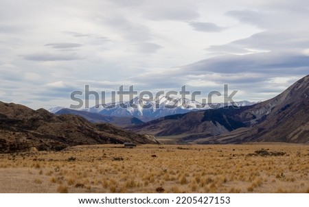 Castle Hill Peak. Canterbury, New Zealand.

A barren landscape looking toward the snow topped Castle Hill Peak on a cold winters day in Christchurch, New Zealand.
