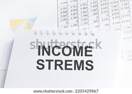 income streams text on an open notebook, business and financial concept