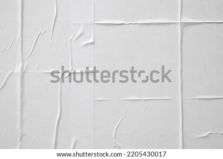white crumpled and creased paper poster texture background Royalty-Free Stock Photo #2205430017