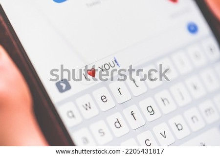 Image of a phone with a love word and a heart written on the message