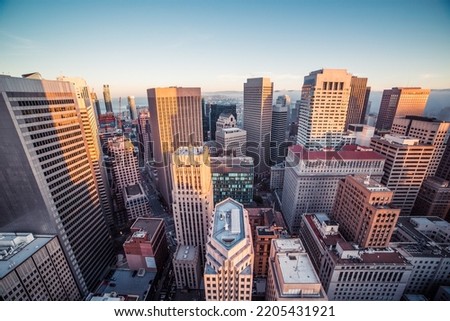 Image of skyscrapers in a modern city with soft sunshine
