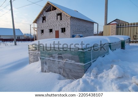 Paving slabs at a construction site in the snow. Winter
