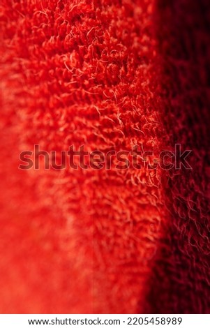 texture of a rough fabric with red holes