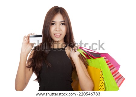 Beautiful Asian woman hold shopping bags show a cradit card  isolated on white background