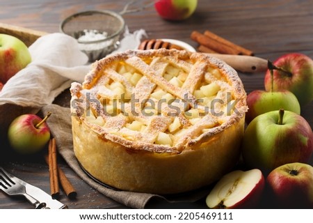 Festive Homemade autumn Apple Pie on dark rustic wooden background. Autumn holiday, fall, thanksgiving day concept.
