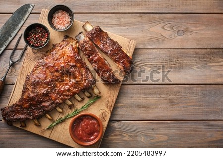 Delicious barbecued ribs seasoned with a spicy basting sauce. Smoked American style pork ribs. Copyspace. Top view. Royalty-Free Stock Photo #2205483997