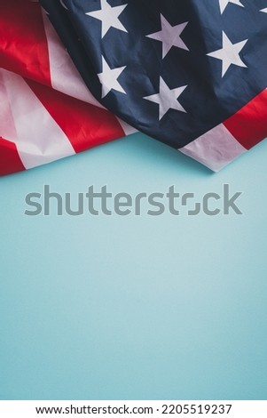 United States election design concept, top view of American Flag over blue table background.