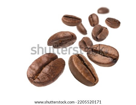 Roasted Coffee beans levitate isolated on a white background. Royalty-Free Stock Photo #2205520171