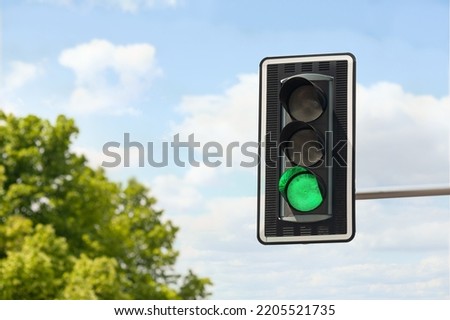 Traffic light against blue sky, space for text Royalty-Free Stock Photo #2205521735
