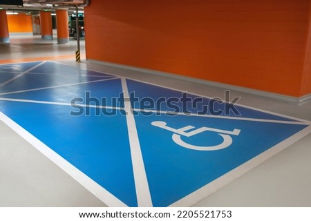 Empty car parking garage with wheelchair symbol