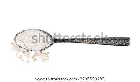 Spoon of oatmeal flour and flakes on white background, top view