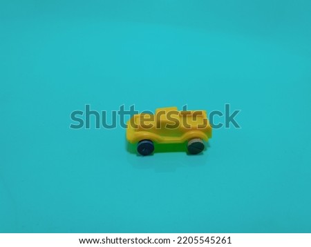 toy car, yellow color vehicle on blue background.