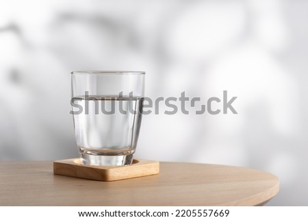Transparent glass with water on a wooden table in the room. Drinking clear water in the morning for health.
 Royalty-Free Stock Photo #2205557669