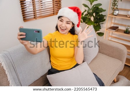 Girl wearing Santa hat and surprise video call for Christmas