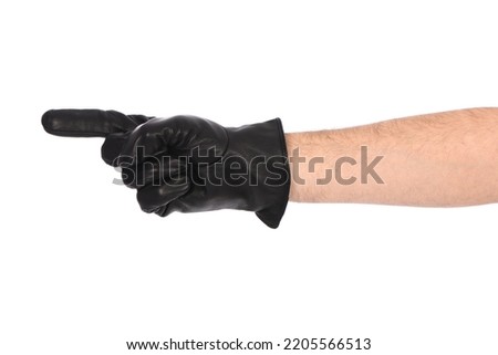 Man wearing black leather glove on white background. Close-up black leather glove showing thumbs up, number one. Side view. High resolution photo. Full depth of field.