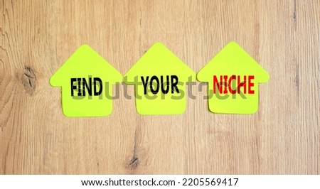 Find your niche symbol. Concept words Find your niche on green papers on papers on wooden clothespins. Beautiful wooden background. Business and find your niche concept. Copy space.