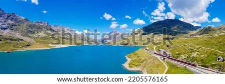 Bernina Pass in Switzerland, aerial view of Lake Bianco, with red train in the station Royalty-Free Stock Photo #2205576165