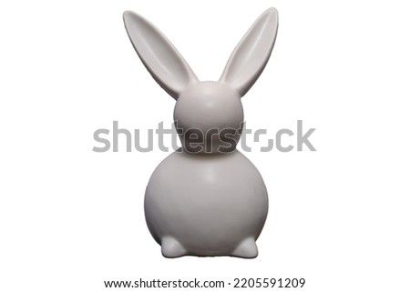 White bunny sculpture. Isolated on white. Easter decoration. White porcelain Easter bunny. The purpose of decoration is to make something more aesthetically pleasing.