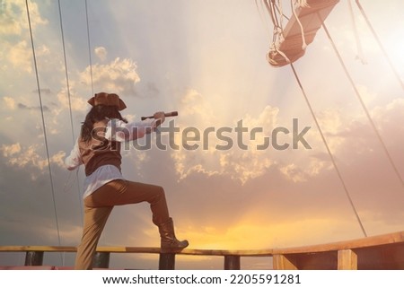 funny the pirate captain traveler  discoverer and explorer on the vintage pirate ship  Royalty-Free Stock Photo #2205591281