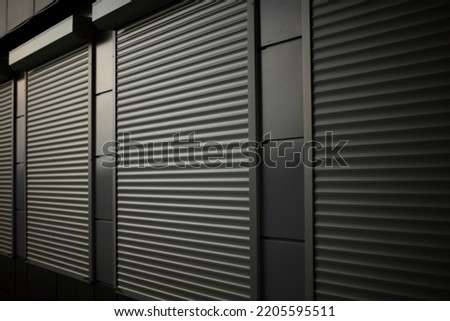 Closed shop. Steel blinds. Blinds on office windows. Ribbed surface. Royalty-Free Stock Photo #2205595511