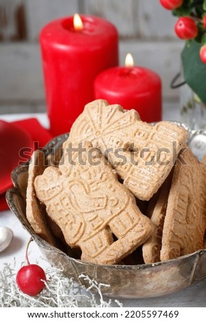 Bowl of speculaas biscuits on the christmas table.