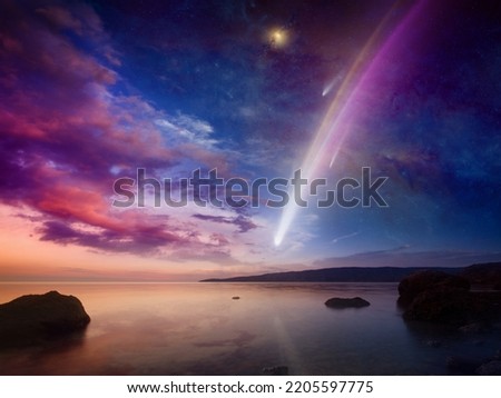 Amazing unreal picture: giant colorful comet in glowing sunset sky over calm sea. Comet is icy small Solar System body. Elements of this image furnished by NASA.