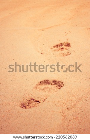 Footprint on sand beach. Vintage filter.