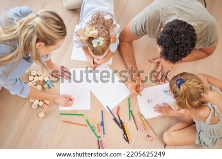 Family with creative children drawing on paper, home school and fun educational activity, learning and project. Above of parents, kids doodle, color and play for healthy growth, development and art Royalty-Free Stock Photo #2205625249