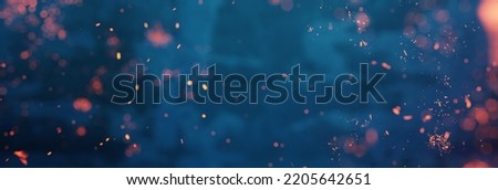 abstract blue background with flying fire particles. Selective Focus
