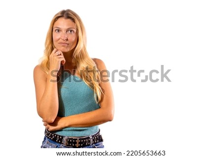 Pretty Hispanic girl on white background with hand on chin thinking about question. smiling with thoughtful face. concept of doubt.