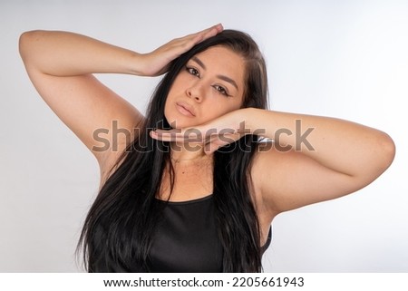 Woman posing on isolated white background, selective focus shot.