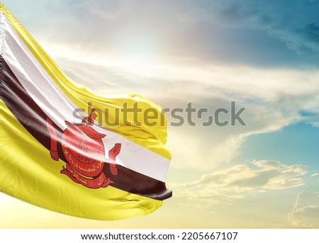 Brunei national flag waving in beautiful sky.