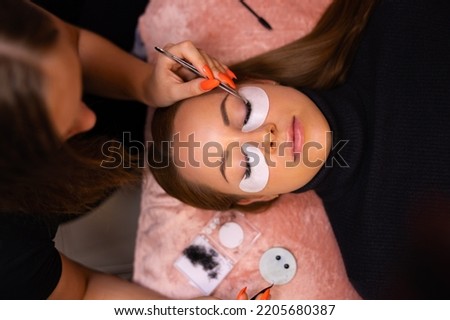 Female Client Going Through Eyelash Extension Procedure Royalty-Free Stock Photo #2205680387