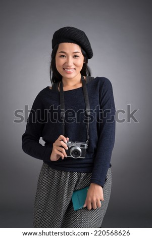 Portrait of Vietnamese young woman with passport and photo camera
