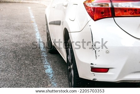 Scraped Rear Bumper of a Parked Car as a Result of Poor Judgment or Inattention, Cosmetic Defect Requiring Repair and Insurance Claim Royalty-Free Stock Photo #2205703353