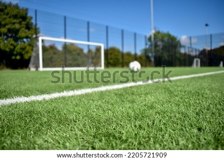 Football field with artificial grass. Royalty-Free Stock Photo #2205721909