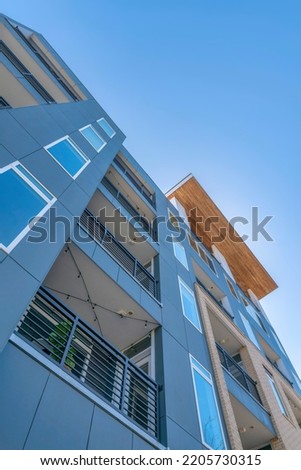 San Antonio, Texas- Low angle view of balconies of an apartment building against the clear sky. View of balcony ceilings with string lights and a view of picture windows.