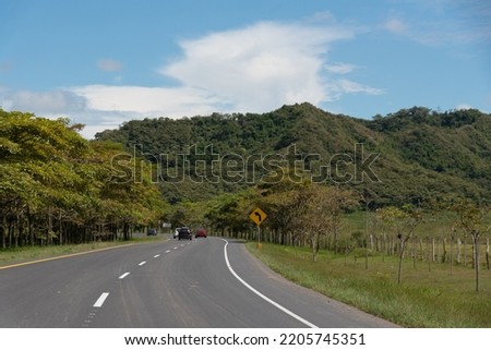 Rural road in an area with trees in a warm climate. Colombia.