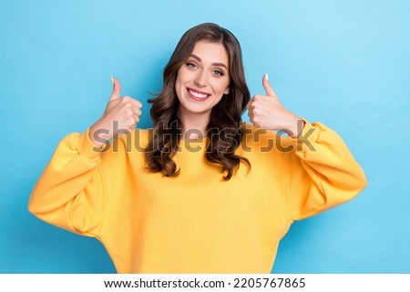 Photo of young student pretty nice perfect woman wear yellow shirt showing thumb up recommend new product information isolated on blue color background