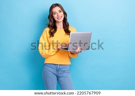 Photo of young positive pretty nice gorgeous girl businesswoman hold computer programmer toothy smile successful isolated on blue color background