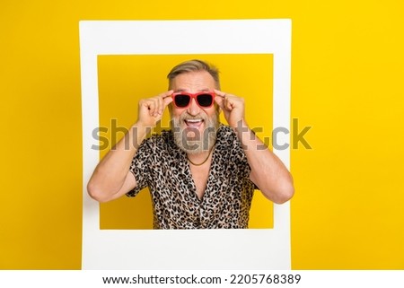 Photo of attractive grandpa touch sunglass social media photo dressed stylish leopard print outfit isolated on yellow color background