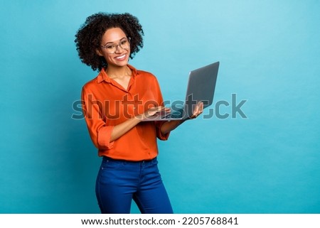 Portrait of beautiful trendy cheery wavy-haired girl using laptop study education isolated on vivid blue color background