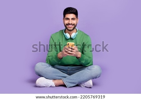 Full size photo of handsome positive good mood guy green pullover write post share follow subscribe isolated on violet color background