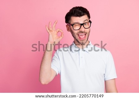 Photo of young attractive handsome funny guy blink eye wear glasses showing okey sign toothy positive isolated on bright pink color background Royalty-Free Stock Photo #2205770149