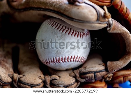 Old school baseball gloves and balls in the garage. Royalty-Free Stock Photo #2205772199