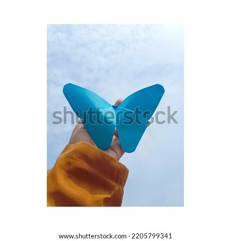 blue butterfly from origami flying in the sky