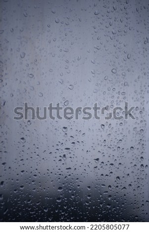 background of a light gray iron shiny sheet of iron, after the rain with dew drops, after the rain, the texture of water drops on a steel sheet with a shadow