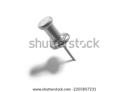 silver color push pin on a white background with shadows over them. Royalty-Free Stock Photo #2205807231