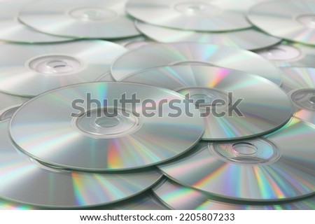 Heap of DVD, CD disks on white background.