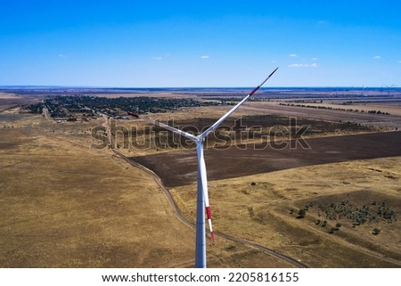 wind power plant in the steppe against the blue sky shooting from a drone. High quality photo